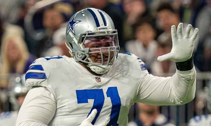 Oct 31, 2021; Minneapolis, Minnesota, USA; Dallas Cowboys offensive tackle La'el Collins (71) indicates he is an eligible receiver entering the game in the third quarter against the Minnesota Vikings at U.S. Bank Stadium. Mandatory Credit: Matt Blewett-USA TODAY Sports
